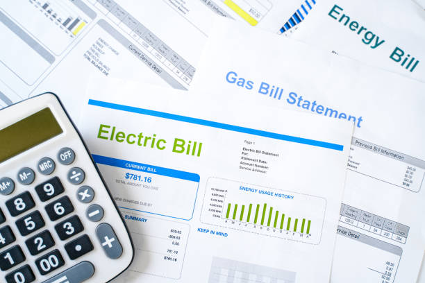 small white calculator on top of electricity bill